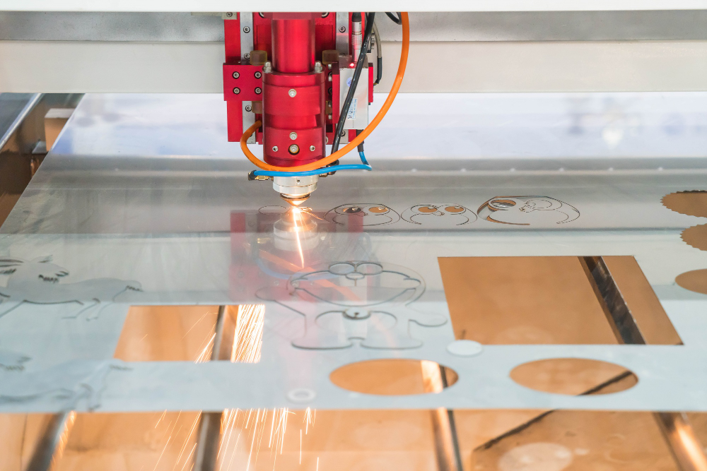 Precision laser engraving machine in action cutting detailed designs on metal material